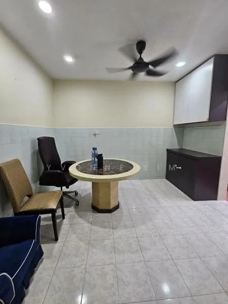 Room features: white painted walls, light grey tiled flooring, round dining table with beige top, black office chair, brown upholstered chair, dark wood cabinetry, ceiling fan, water bottle on table; style: modern.