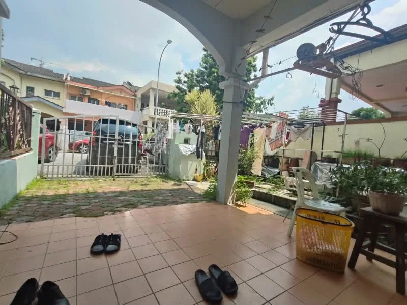 Exterior type: linked terrace house; features: paved walkway, fenced front yard, manicured lawn, clothesline with laundry, car parked in driveway, outdoor seating area, garden with potted plants, gate at entrance; style: modern.