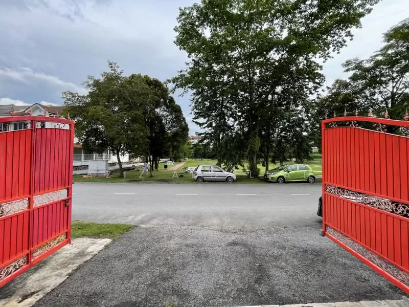 Exterior features: red gate, gravel driveway, green lawn, mature trees, street view, parked cars, sidewalk.