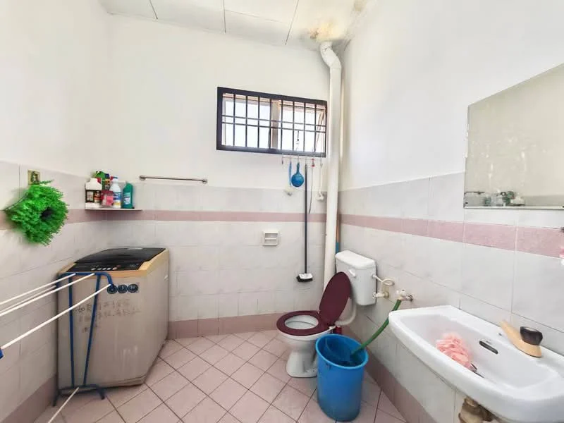 Laundry features: washing machine, toilet, sink, mirror, window, pink tiled walls, light grey floor tiles, clothes drying rack, blue bucket.
