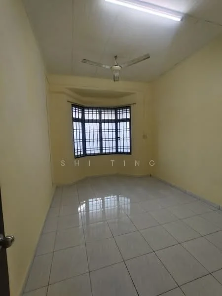 Room features: yellow painted walls, white tiled flooring, ceiling fan, large window with black grille, natural light from window, plain ceiling, no visible furniture, corner room layout; style: minimalist.
