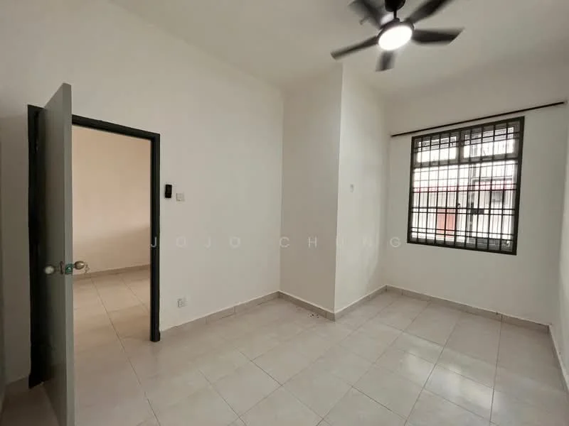 Room features: white painted walls, tile flooring, ceiling fan, large window with security bars, doorway leading to another room, neutral color scheme, corner location, no visible furniture; style: minimalist.
