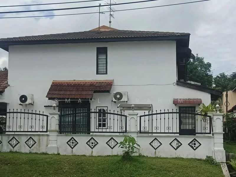 Exterior type: detached bungalow; features: white painted facade, red tile roof, black wrought iron fence, two wall-mounted split AC units, single-storey, decorative wall patterns, manicured lawn, mature greenery, front porch, windows with black grills; style: traditional.