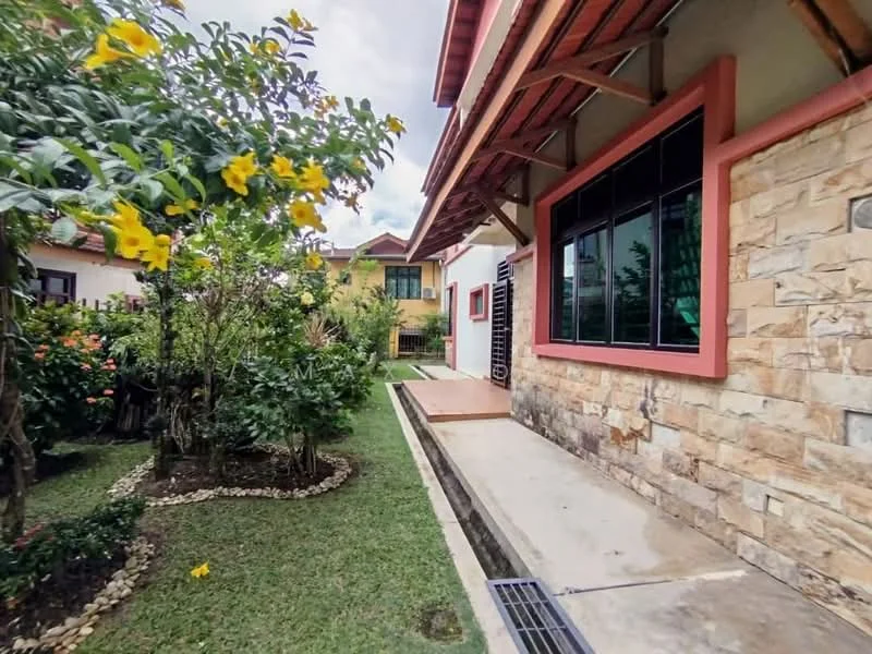 Exterior type: detached bungalow; features: stone cladding on facade, red painted trim, wooden overhang, manicured lawn, flowering shrubs, landscaped garden, paved walkway, outdoor wooden deck; style: modern.
