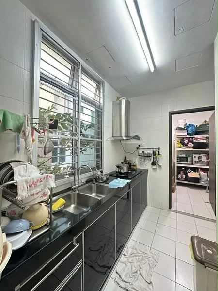 Kitchen features: double-bowl stainless-steel sink, chrome pull-down faucet, black glossy cabinetry, white tiled walls, white tiled flooring, stainless-steel range hood, window with metal grilles, open shelving, dish rack with dishes, kitchen appliances visible in pantry, light fixtures on ceiling; style: modern. Room features: storage shelves with various items.