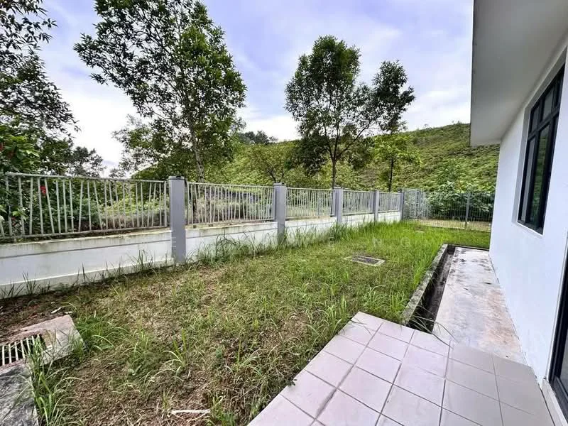 Exterior features: fenced yard, manicured lawn, paved patio area, surrounding greenery, sloped terrain, concrete boundary wall; style: modern.