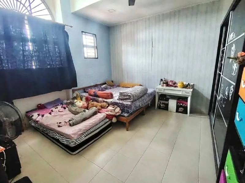 Bedroom features: two single beds with bedding, blue painted walls, light-colored tile flooring, black curtains, small window, white dresser, colorful storage cabinet, decorative items on dresser, stuffed animals on bed, fan in corner.