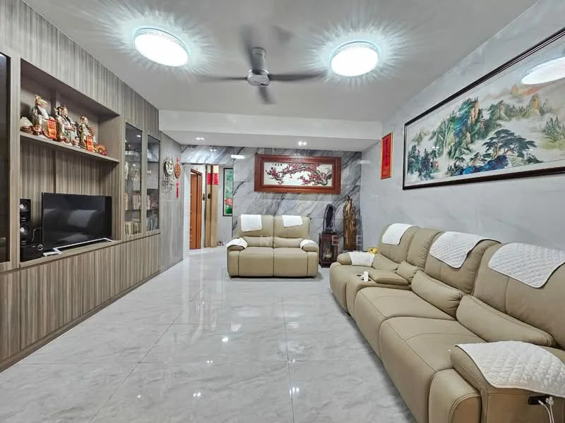 Living features: light grey marble tile flooring, white painted walls, wood panel feature wall, recessed ceiling lights, 2-seater beige leather sofa, 3-seater beige leather sofa, wall-mounted TV, decorative wall art with landscape, ceiling fan, built-in cabinetry with display shelves, decorative figurines on shelves, red wall hanging, open layout to hallway; style: modern.