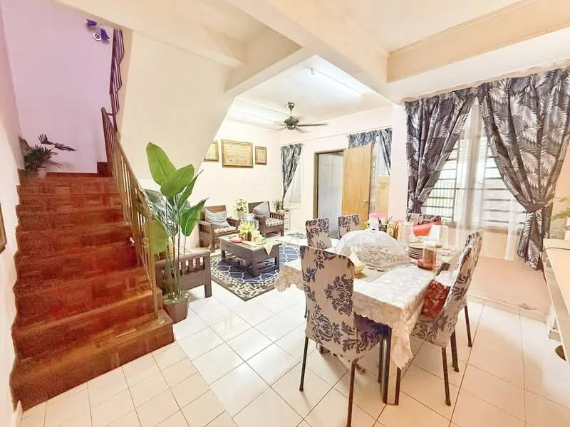 Dining features: dining table with floral-patterned tablecloth, 8 upholstered dining chairs with floral pattern, white tiled flooring, ceiling fan, large window with sheer curtains, decorative wall art, indoor plants, open layout to living area; style: modern. Living features: 3-seater fabric sofa in dark color, 2 armchairs in dark color, coffee table, area rug with geometric pattern, wall-mounted artwork, large window with patterned curtains, wooden staircase, indoor plants; style: modern.