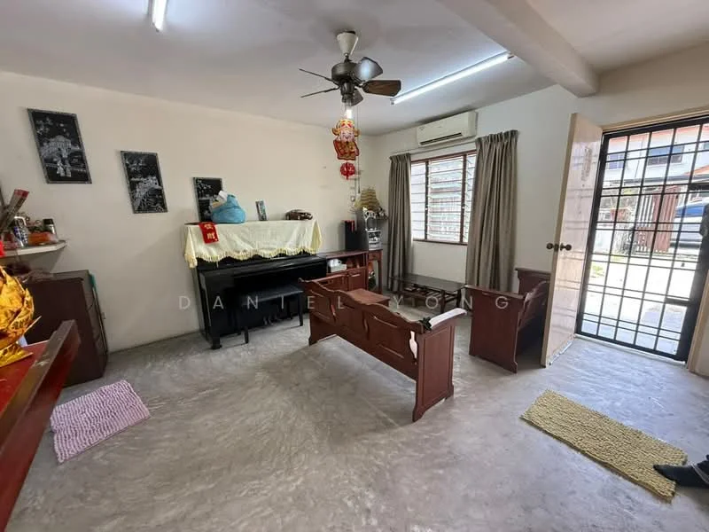 Living features: grey polished concrete flooring, white painted walls, ceiling fan with light, large window with security bars, wooden piano, wooden furniture, curtains, decorative wall art, area rug, door leading outside; style: minimalist.