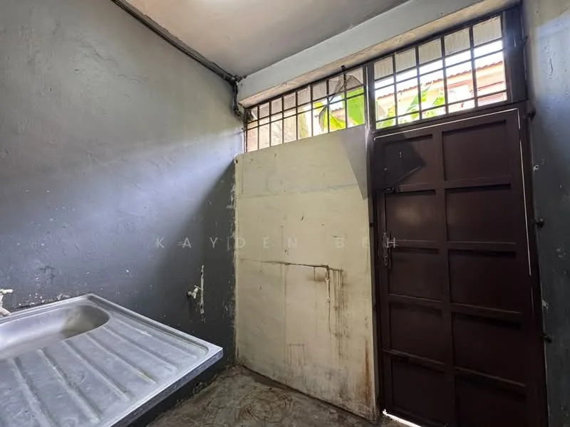 Laundry features: single-bowl stainless-steel sink, grey painted walls, concrete flooring, metal door, window with metal bars, natural light from window.