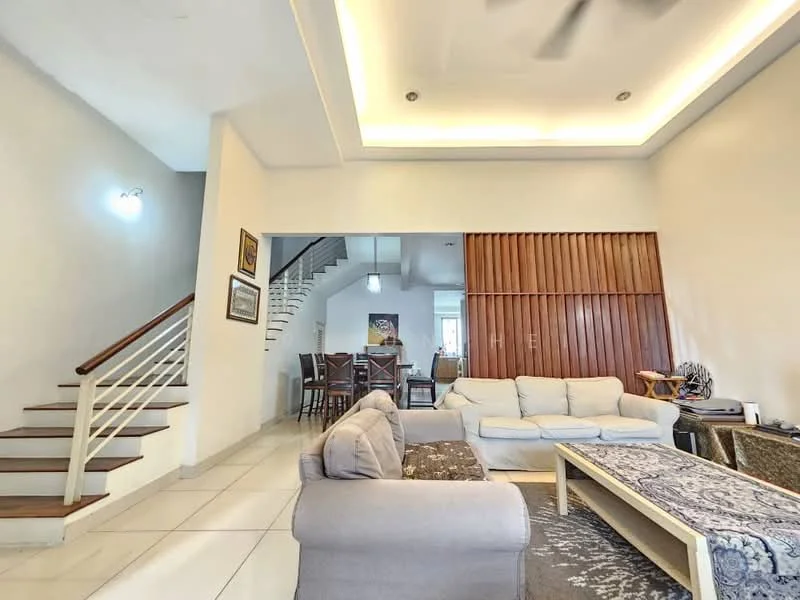 Living features: white painted walls, tray ceiling with recessed lighting, large windows, light-colored sofa, dark patterned sofa, wooden coffee table, area rug with geometric pattern, ceiling fan, wooden staircase, dining area visible in background, decorative wall paneling; style: modern.