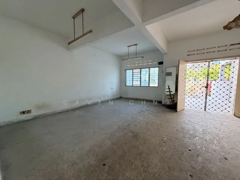 Room features: white painted walls, concrete flooring, exposed ceiling beams, large windows, metal security grille door, natural light from windows, no visible furniture, minimal decor; style: minimalist; view: garden.