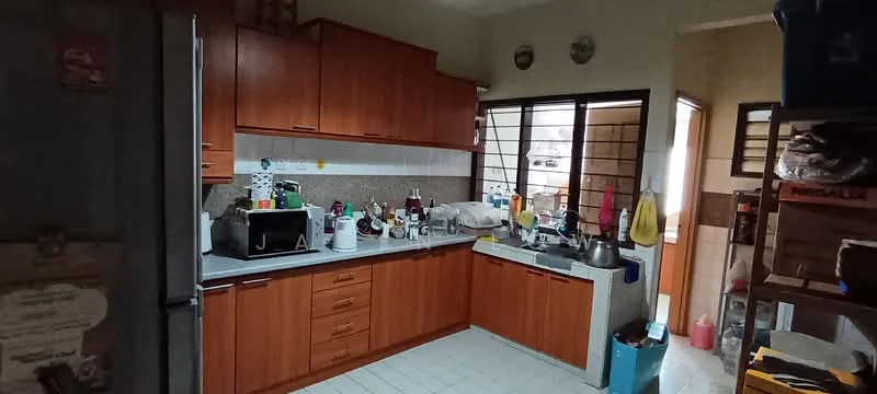 Kitchen features: brown wooden cabinetry, grey countertop, stainless-steel sink, chrome pull-down faucet, built-in microwave, black microwave oven, refrigerator, ceramic tile flooring, window with metal grille, wall-mounted shelves, various kitchen appliances, cluttered countertop.