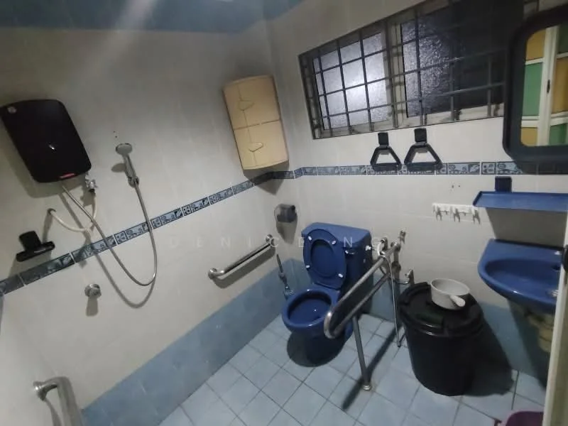 Bathroom features: blue tiled walls, white tiled flooring, toilet with grab bars, handheld shower with wall mount, shower head, sink with mirror, wall-mounted storage cabinet, grab bars for accessibility, waste bin.