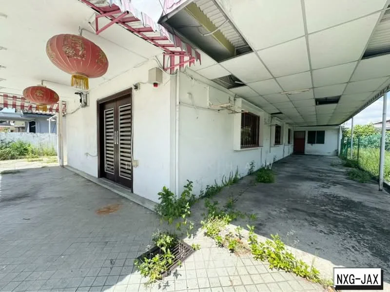 Exterior type: detached bungalow; features: white painted facade, flat roof, covered walkway, paved flooring, mature greenery, hanging lanterns, open space, perimeter fencing; style: traditional.