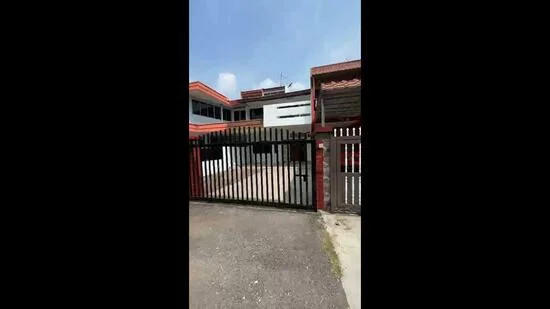 Exterior type: detached bungalow; features: gated entrance, black metal gate, red brick facade, white painted facade, flat roof, two-storey, manicured lawn, paved driveway, surrounded by greenery, multiple windows, balconies on upper floor; style: modern.
