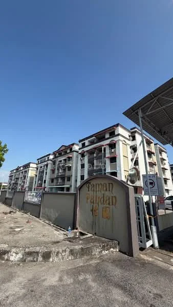 Exterior type: low-rise apartment block; features: cream painted facade, red tiled roof, balconies with railings, multiple storeys, signage at entrance, surrounding wall, parking area, clear blue sky; style: modern.