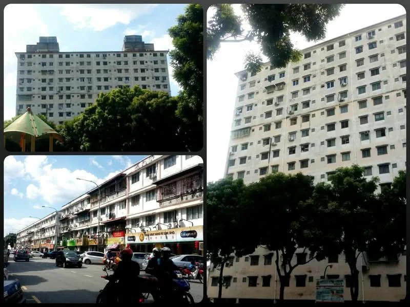 Exterior type: mid-rise condominium; features: white painted facade, approximately 8-storey building, flat roof, balconies visible on upper floors, surrounded by trees, street view with shops at ground level, windows with metal grilles, parking spaces visible on street; style: modern.