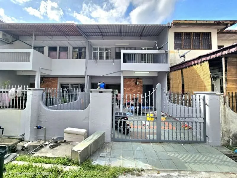 Exterior type: linked terrace house; features: grey painted facade, brick accent wall, flat roof, gated entrance, paved driveway, manicured lawn, fence with vertical bars, outdoor space with tiles, windows with grilles, covered porch; style: modern.