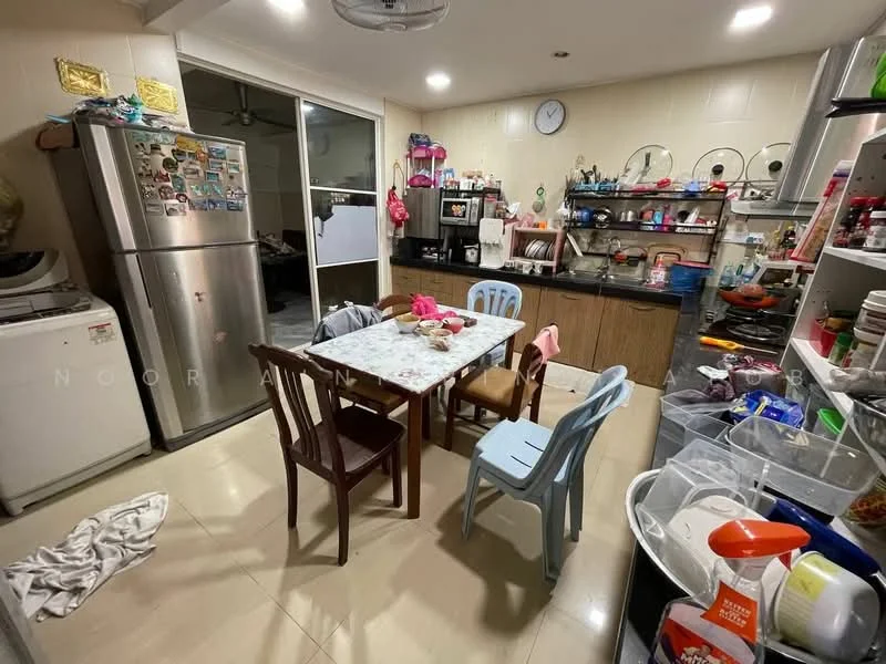 Kitchen features: stainless-steel fridge, built-in oven, microwave, black countertop, wood cabinetry, ceramic tile flooring, kitchen table with four chairs, sink, wall-mounted shelves, various kitchen utensils, washing machine, clock on wall, decorative items on shelves.