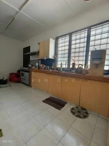 Kitchen features: white tiled flooring, light wood cabinetry, stainless-steel gas stove, built-in oven, kitchen sink, countertop with space for appliances, window with grid pattern, water dispenser, various kitchen utensils and containers on countertop, red and black storage bins, area rug in front of sink.