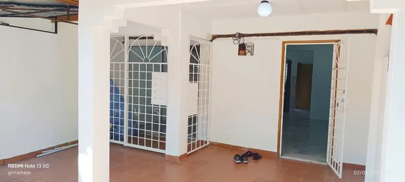 Room features: white painted walls, tile flooring, open layout, two sets of double doors, ceiling light fixture, exposed ceiling beams, window with security grille, doorway leading to another room; style: modern.