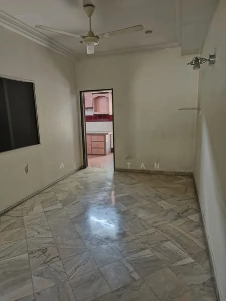 Room features: marble flooring, white painted walls, ceiling fan, doorway leading to kitchen, window with dark frame, light fixture on wall, corner wall sconce, high ceiling with crown moulding.