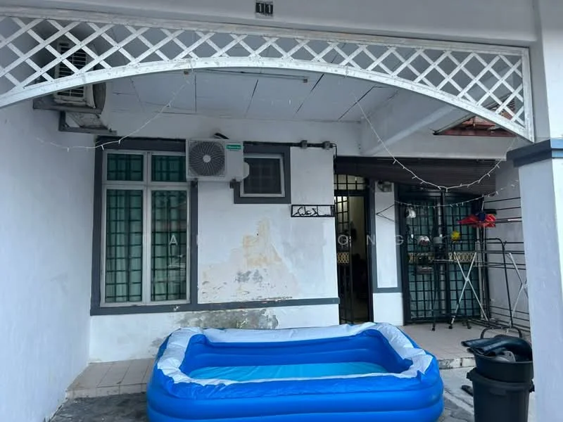 Exterior type: linked terrace house; features: white painted facade, arched entrance with lattice design, 1 wall-mounted split AC, green-framed windows, exposed brick wall, outdoor area with tiled flooring, inflatable pool, clothes drying rack, garbage bin; style: traditional.