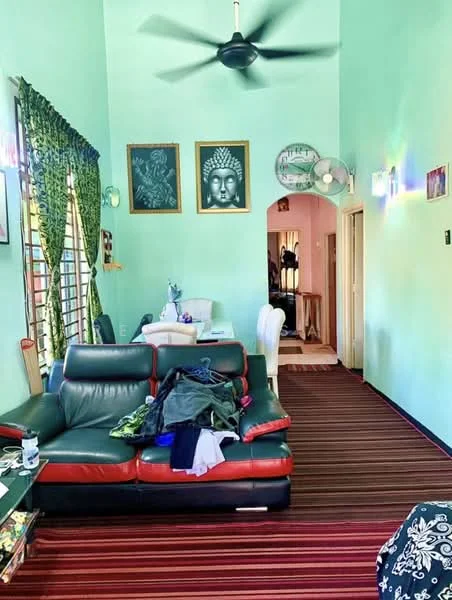 Living features: green painted walls, striped carpet flooring, 3-seater leather sofa in black and red, ceiling fan, wall-mounted artwork, decorative wall mirrors, dining table with white chairs, arched doorway leading to hallway; style: contemporary.