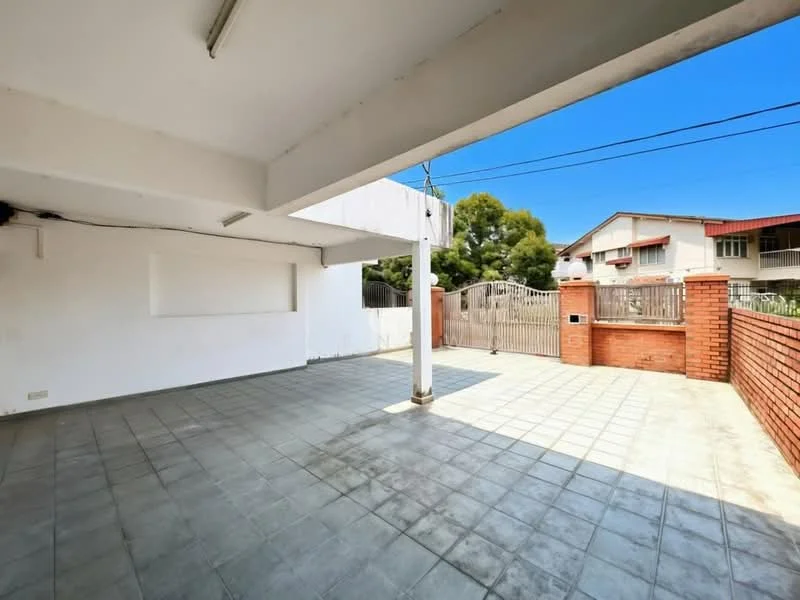 Exterior features: open outdoor space, brick wall, paved flooring, fenced perimeter, gate access, clear blue sky, surrounding greenery; style: modern.