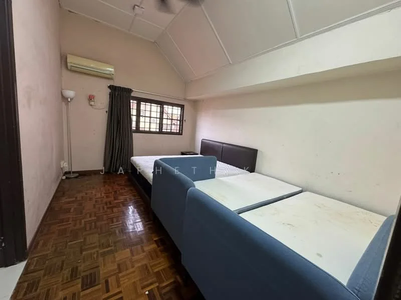 Bedroom features: two single beds, wooden parquet flooring, white painted walls, ceiling fan, window with grille, curtains, wall-mounted air conditioning unit.