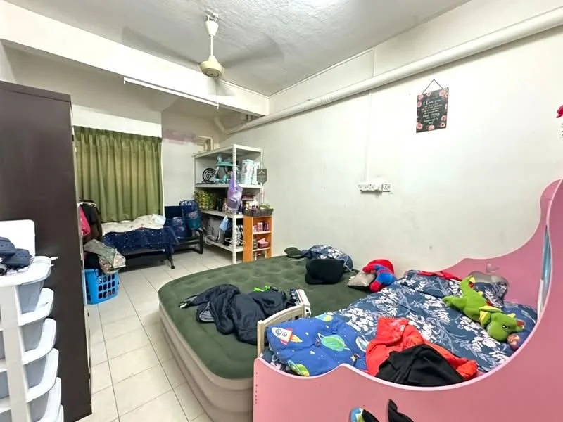 Bedroom features: green curtains, ceiling fan, tiled flooring, bunk bed with pink frame, mattress on floor, clothes on bed, storage shelves, laundry basket, wall-mounted hooks, decorative wall art.