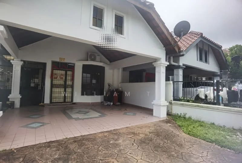 Exterior type: semi-detached house; features: tiled porch area, stone-paved driveway, gabled roof with tiles, white painted facade, front porch with columns, fenced yard, visible air conditioning unit, satellite dish, manicured lawn, adjacent house visible; style: modern.