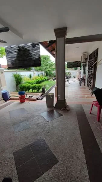 Room features: outdoor patio area, stone flooring, wooden ceiling, ceiling fan, decorative columns, garden view, greenery in background, outdoor seating area, bar stools, planters, red plastic chair; style: modern; view: garden.