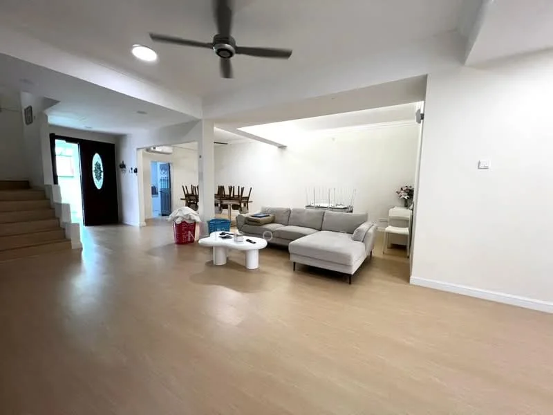 Living features: light wood flooring, white painted walls, 5-blade ceiling fan, sofa in light grey fabric, coffee table with white surface, decorative vase with flowers, dining table with chairs visible in background, natural light from windows, open layout, wall-mounted light fixture; style: modern.