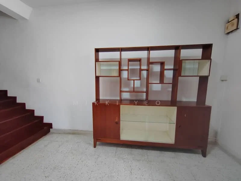 Room features: white painted walls, grey flooring, wooden display cabinet with glass doors, staircase with red carpet, built-in shelving unit, minimalist decor; style: modern.
