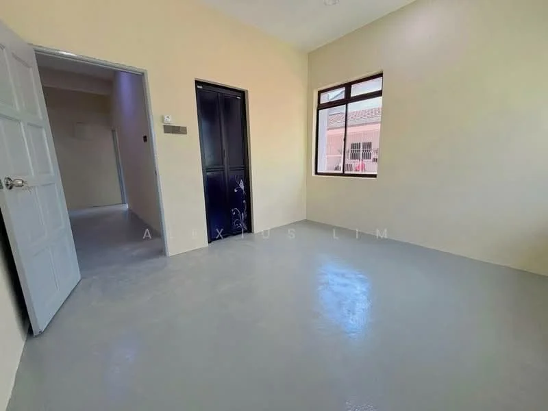 Room features: light grey flooring, cream painted walls, single window with white frame, door with black finish, plain ceiling, no visible furniture; style: minimalist.