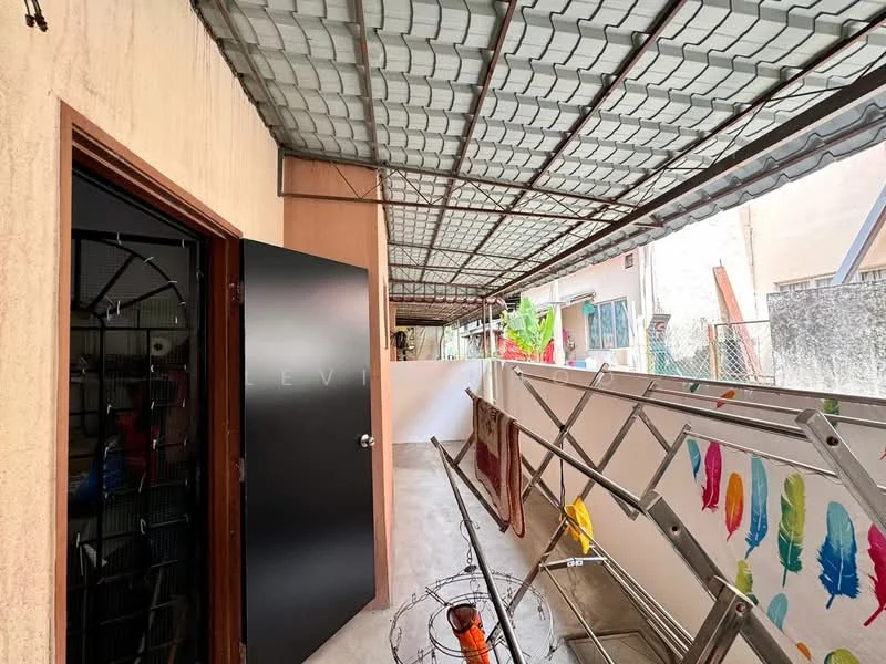 Room features: metal roof, concrete flooring, exterior wall with beige finish, black door, ladder, colorful wall decoration, outdoor space, overhead awning.