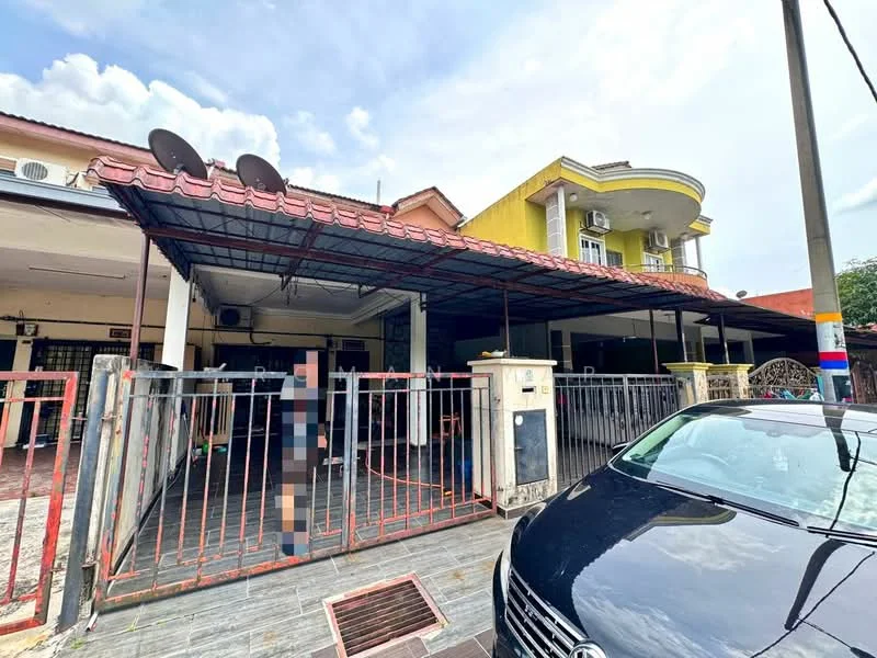 Exterior type: semi-detached house; features: red tiled roof, yellow painted facade, metal gate, fenced front yard, car porch, two air conditioning units visible, outdoor seating area, paved driveway, satellite dishes on roof; style: modern.