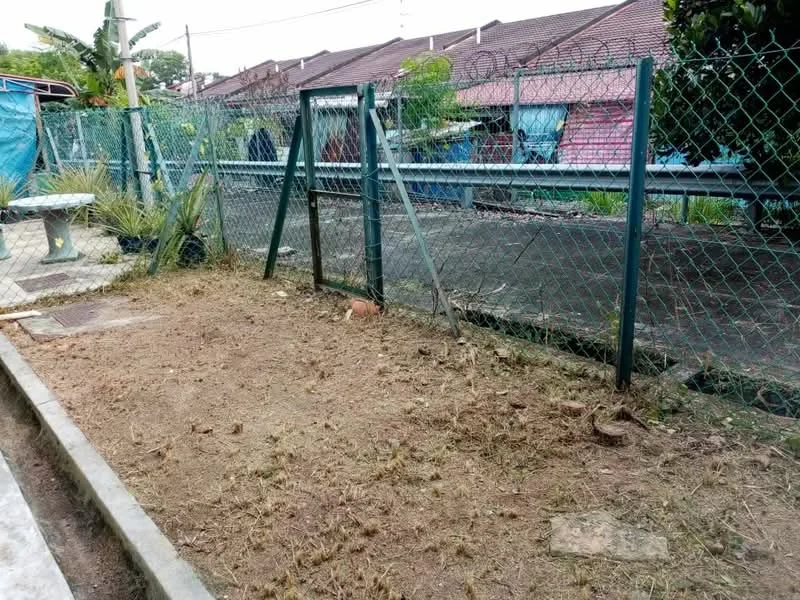 Exterior features: chain-link fence, gravel ground, swing set frame, overgrown grass, surrounding residential area, concrete pathway.