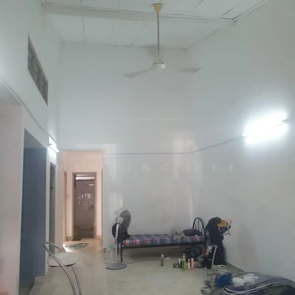 Room features: white painted walls, ceiling fan, tile flooring, two wall-mounted lights, single bed with checkered bedding, folding chair, fan, cluttered space; style: minimalist.