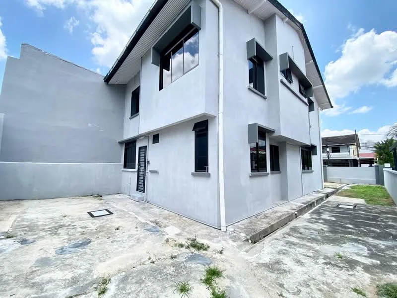 Exterior type: semi-detached house; features: grey painted facade, flat roof, two-storey structure, multiple windows, concrete driveway, manicured lawn, surrounding wall, side pathway; style: modern.