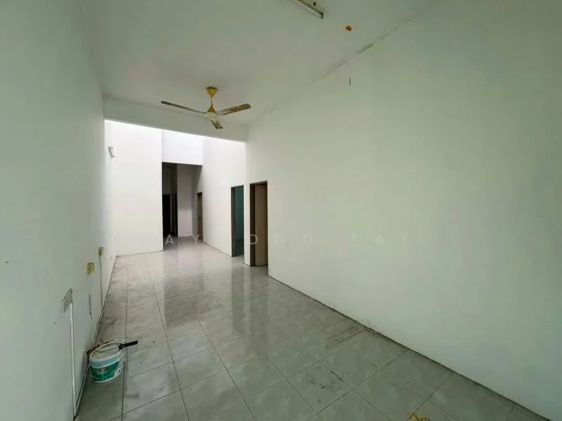Room features: white painted walls, grey tiled flooring, 5-blade ceiling fan, doorway leading to another room, doorway leading to hallway, high ceiling, natural light from skylight, no visible furniture or decor; style: minimalist.