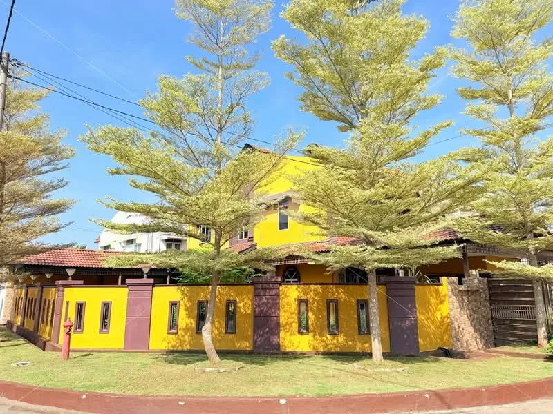 Exterior type: detached bungalow; features: yellow painted facade, purple trim around windows, gabled roof, single-storey, manicured lawn, mature trees, paved walkway, front porch, multiple windows, brick wall fencing; style: modern.