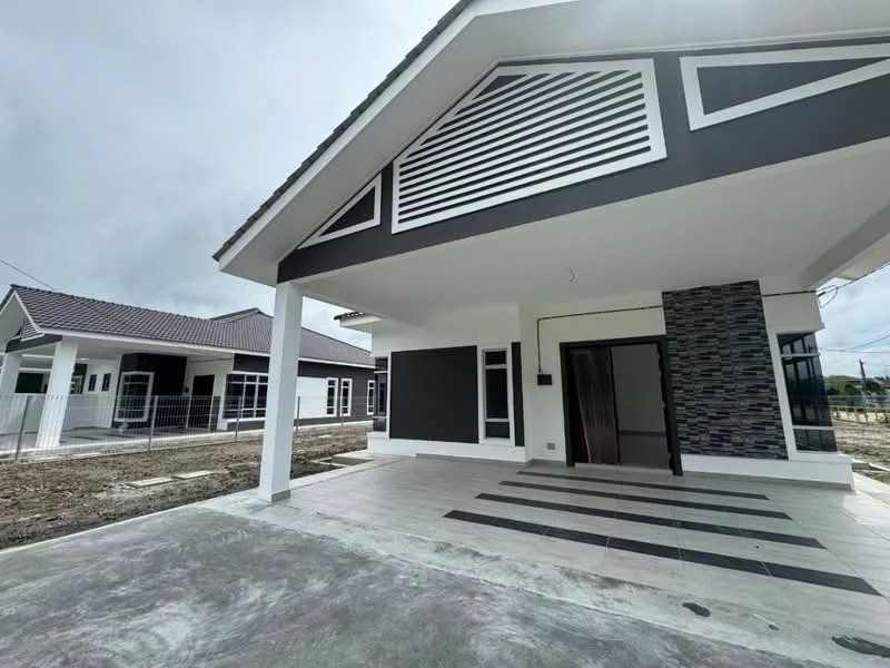 Exterior type: detached bungalow; features: grey painted facade, stone cladding accent wall, flat roof, recessed balconies, wide entrance steps, manicured lawn area, paved walkway, surrounded by open space; style: modern.