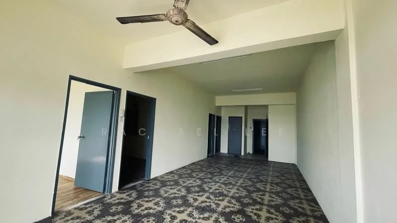 Room features: ceiling fan, light-colored painted walls, decorative floor tiles with floral pattern, two doors visible, wooden flooring, large open space, no visible furniture, windows not visible.