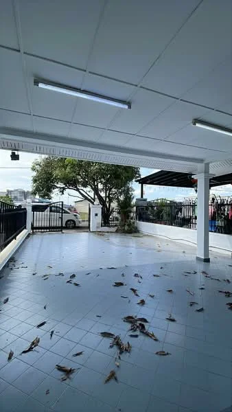 Exterior type: car porch; features: tiled flooring, covered roof, perimeter fence, gate at entrance, tree providing shade, open space, surrounded by greenery; style: modern.