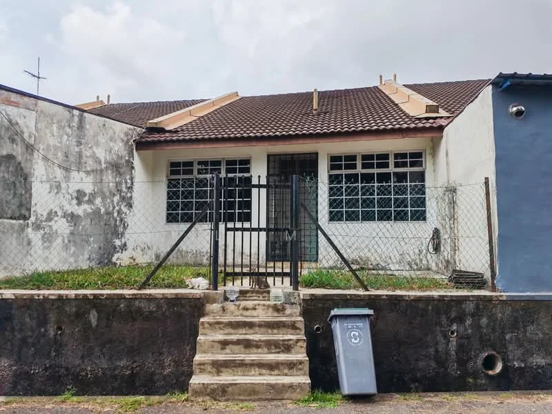Exterior type: semi-detached house; features: brown tiled roof, white painted facade, metal gate, front steps, fenced yard, concrete wall, grass lawn, two front windows, utility bin, exposed brick wall, metal crossbars on windows; style: traditional.