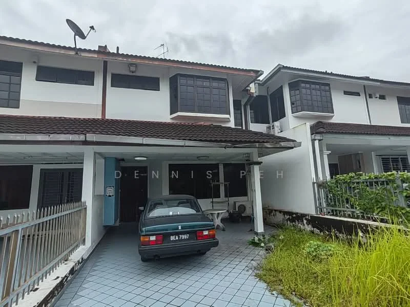 Exterior type: linked terrace house; features: two-storey structure, brown tiled roof, white painted facade, black framed windows, car porch with driveway, paved driveway, overgrown grass, satellite dish on roof, fenced front yard; style: modern.